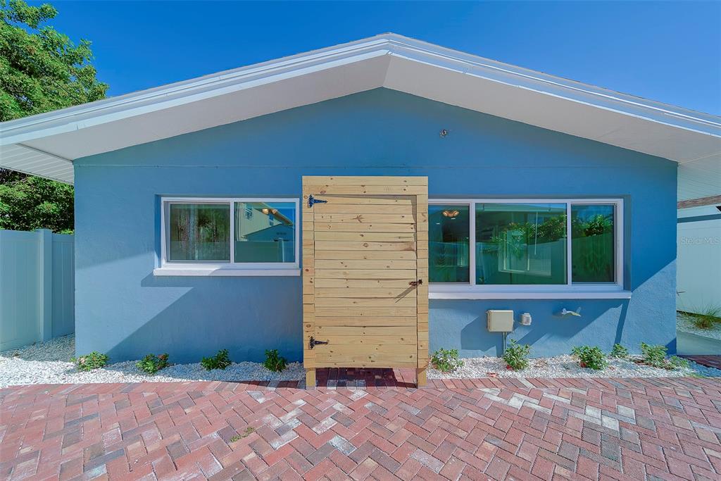 13248 4th Street East, Unit A Madeira Beach, FL 33708 - Photo 25 of 54 a front view of a house with a yard