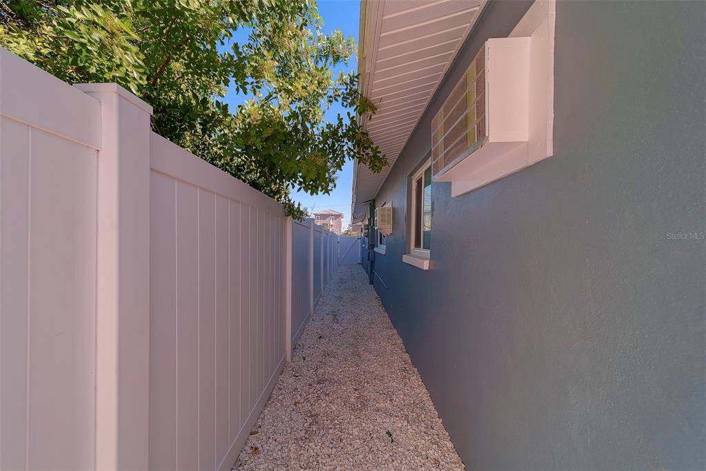 13248 4th Street East, Unit A Madeira Beach, FL 33708 - Photo 27 of 54 a view of a pathway of a house with wooden fence