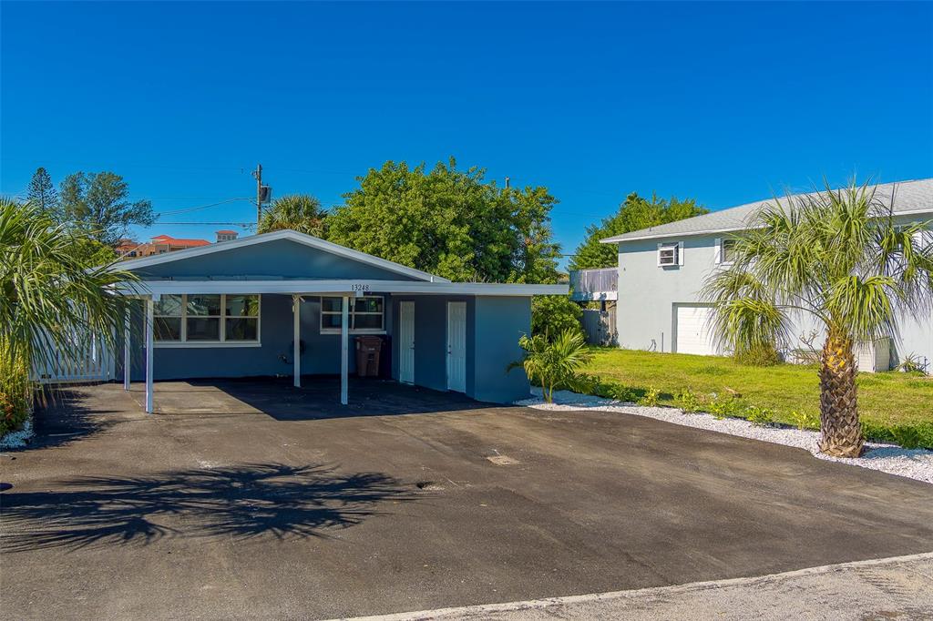 13248 4th Street East, Unit A Madeira Beach, FL 33708 - Photo 34 of 54 a view of a house with a yard