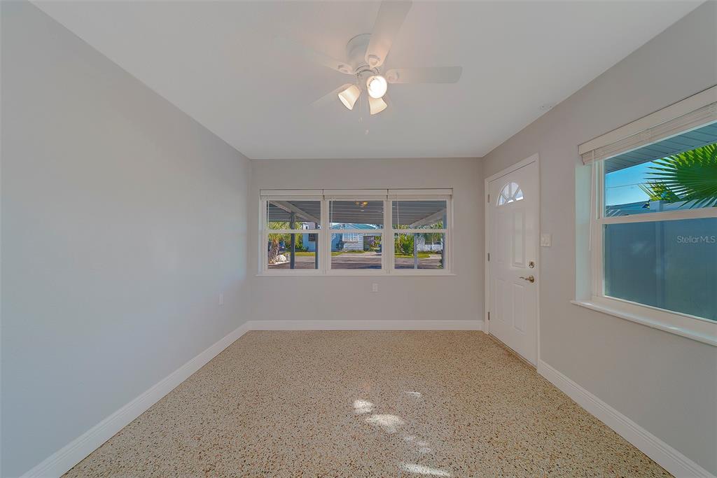 13248 4th Street East, Unit A Madeira Beach, FL 33708 - Photo 6 of 54 an empty room with windows and entrance