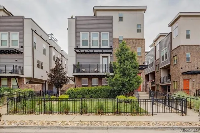 a front view of a building with a garden