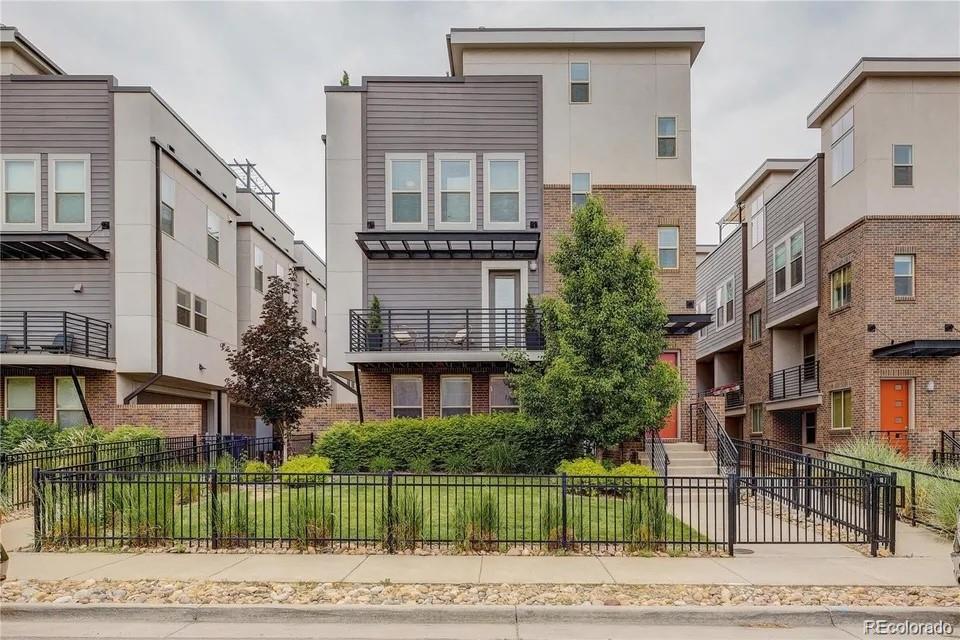 a front view of a building with a garden