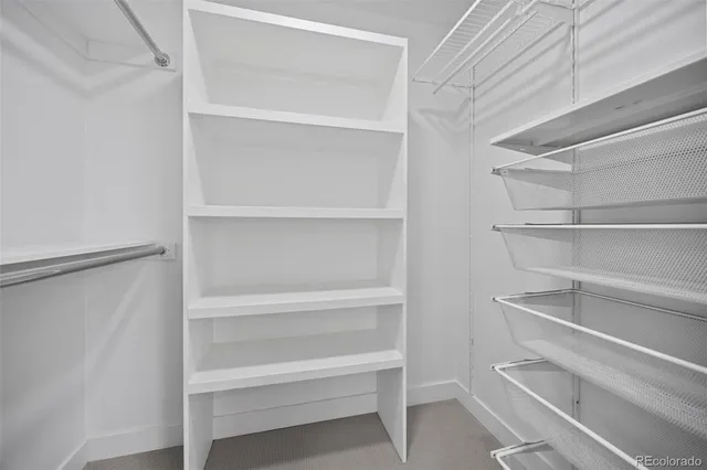 an empty room with closet and windows