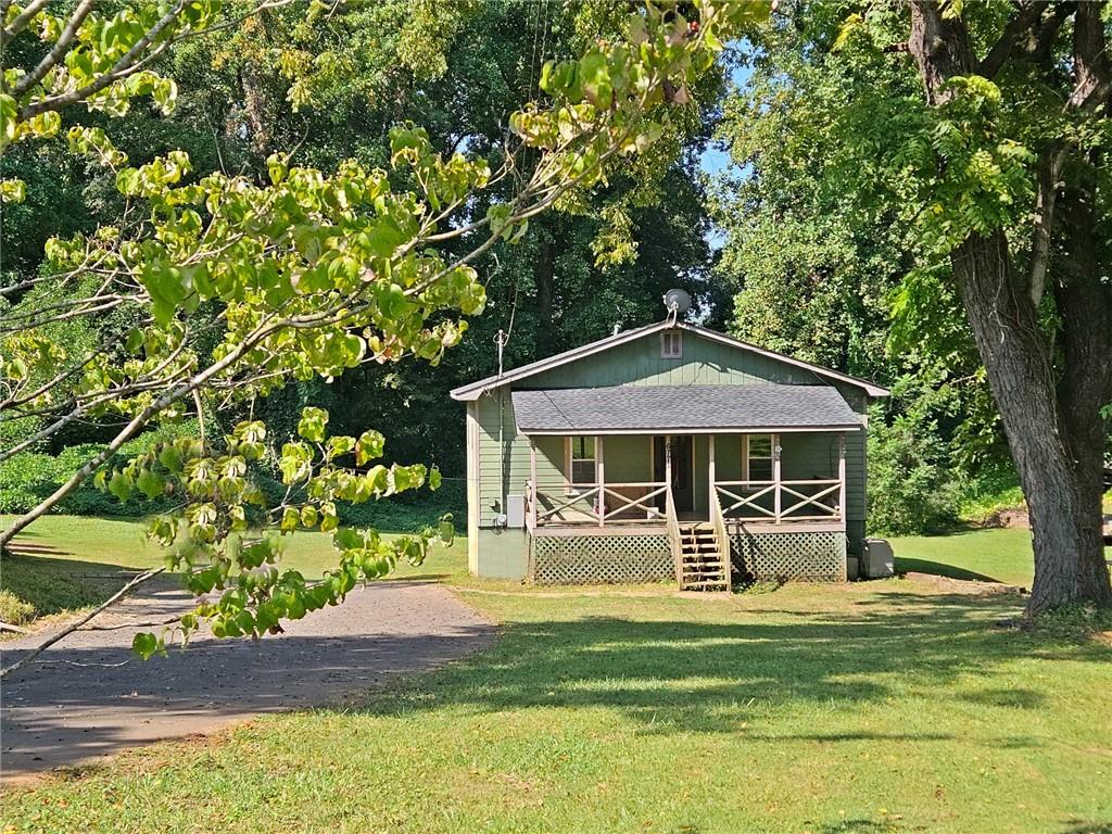6771 Highway 53 Tate, GA 30177 - Photo 1 of 1 a front view of a house with a yard table and chairs
