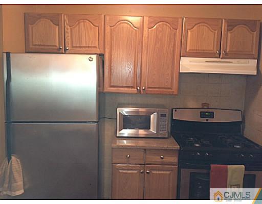 221 Edpas Road New Brunswick, NJ 08901 - Photo 6 of 18 a kitchen with appliances and cabinets