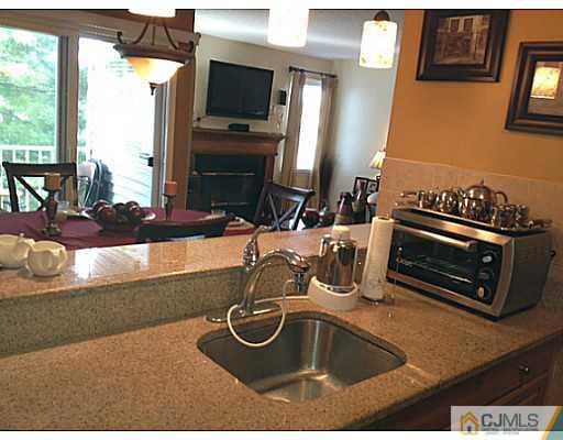 221 Edpas Road New Brunswick, NJ 08901 - Photo 7 of 18 a kitchen with a sink a stove and a microwave
