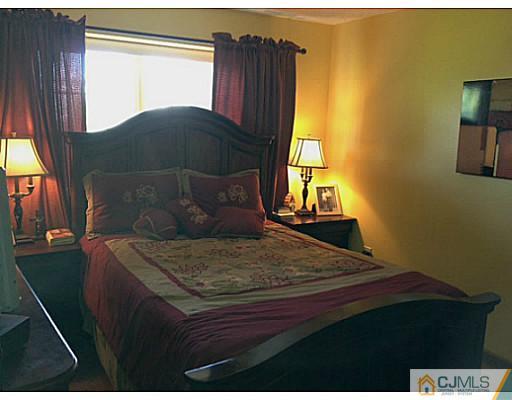 221 Edpas Road New Brunswick, NJ 08901 - Photo 9 of 18 a bed sitting in a bedroom next to a window