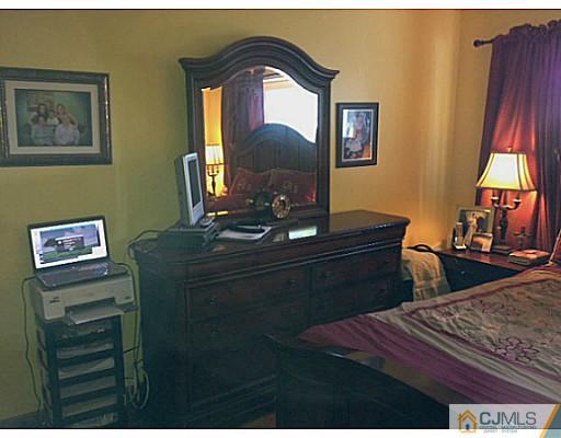 221 Edpas Road New Brunswick, NJ 08901 - Photo 10 of 18 a bedroom with a bed and a dresser