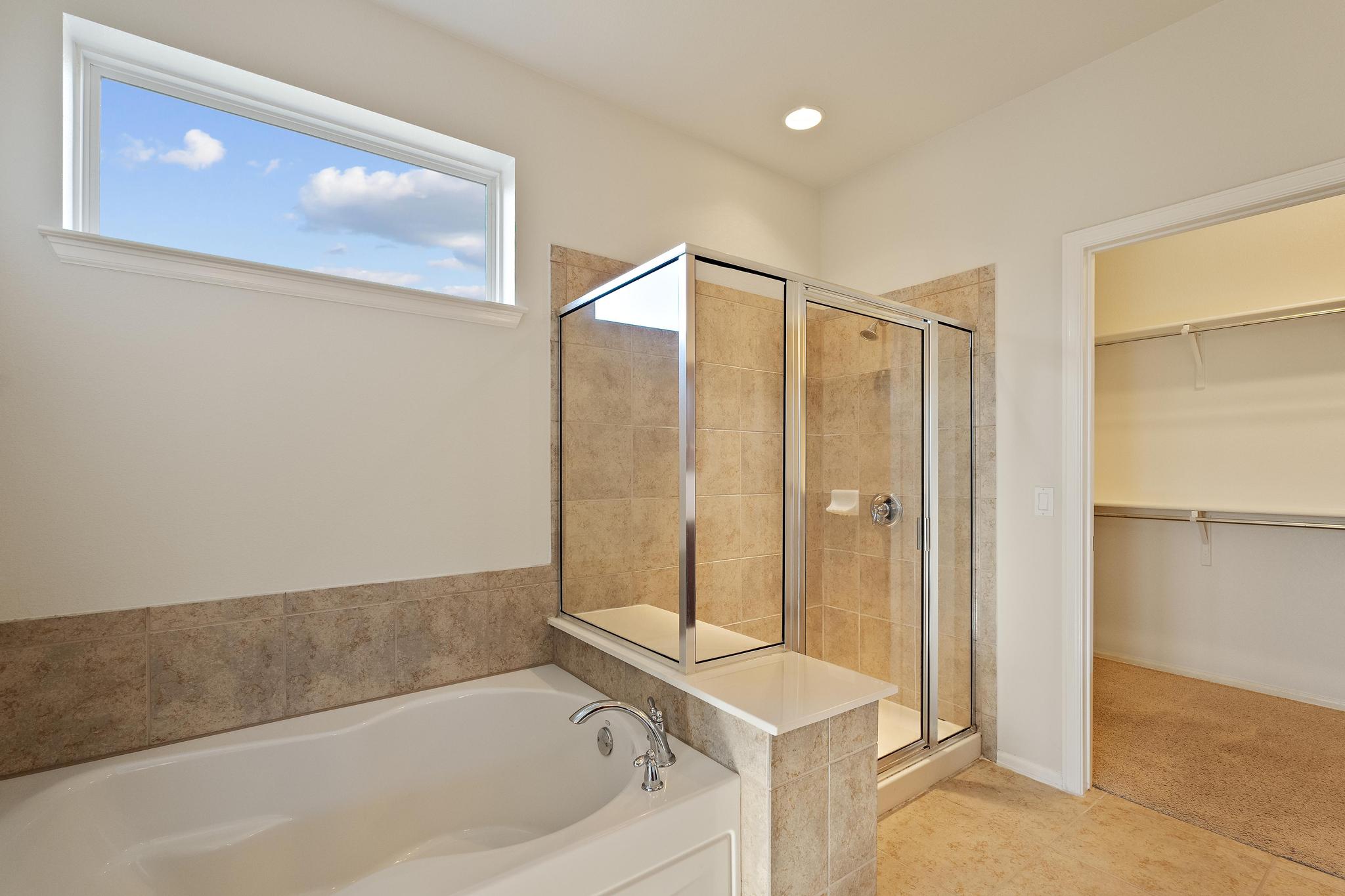 136 Prairie Creek Trail Georgetown, TX 78633 - Photo 19 of 31 a bathroom with a tub a sink and a shower