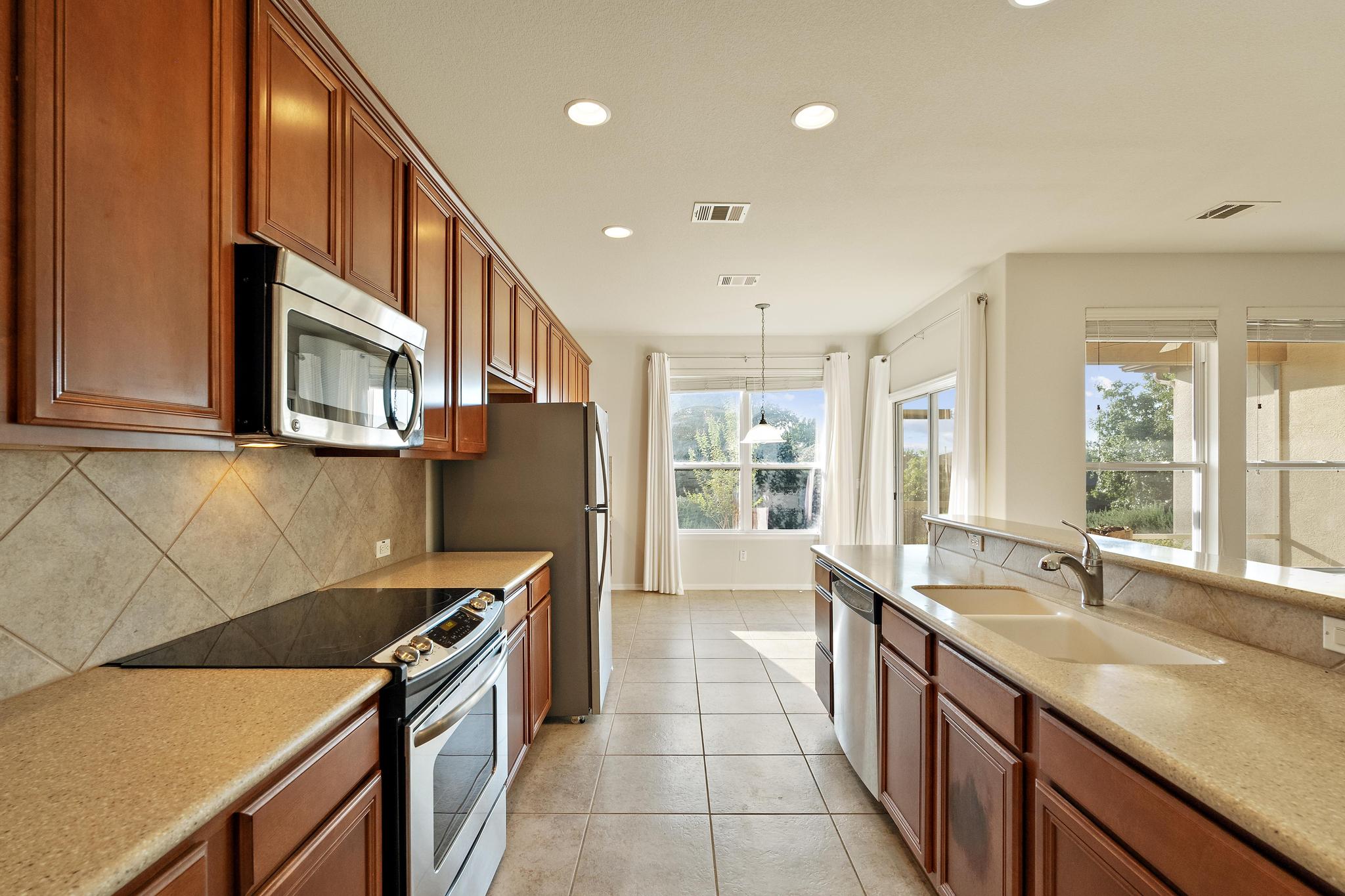 136 Prairie Creek Trail Georgetown, TX 78633 - Photo 6 of 31 a kitchen with stainless steel appliances granite countertop a sink and a stove