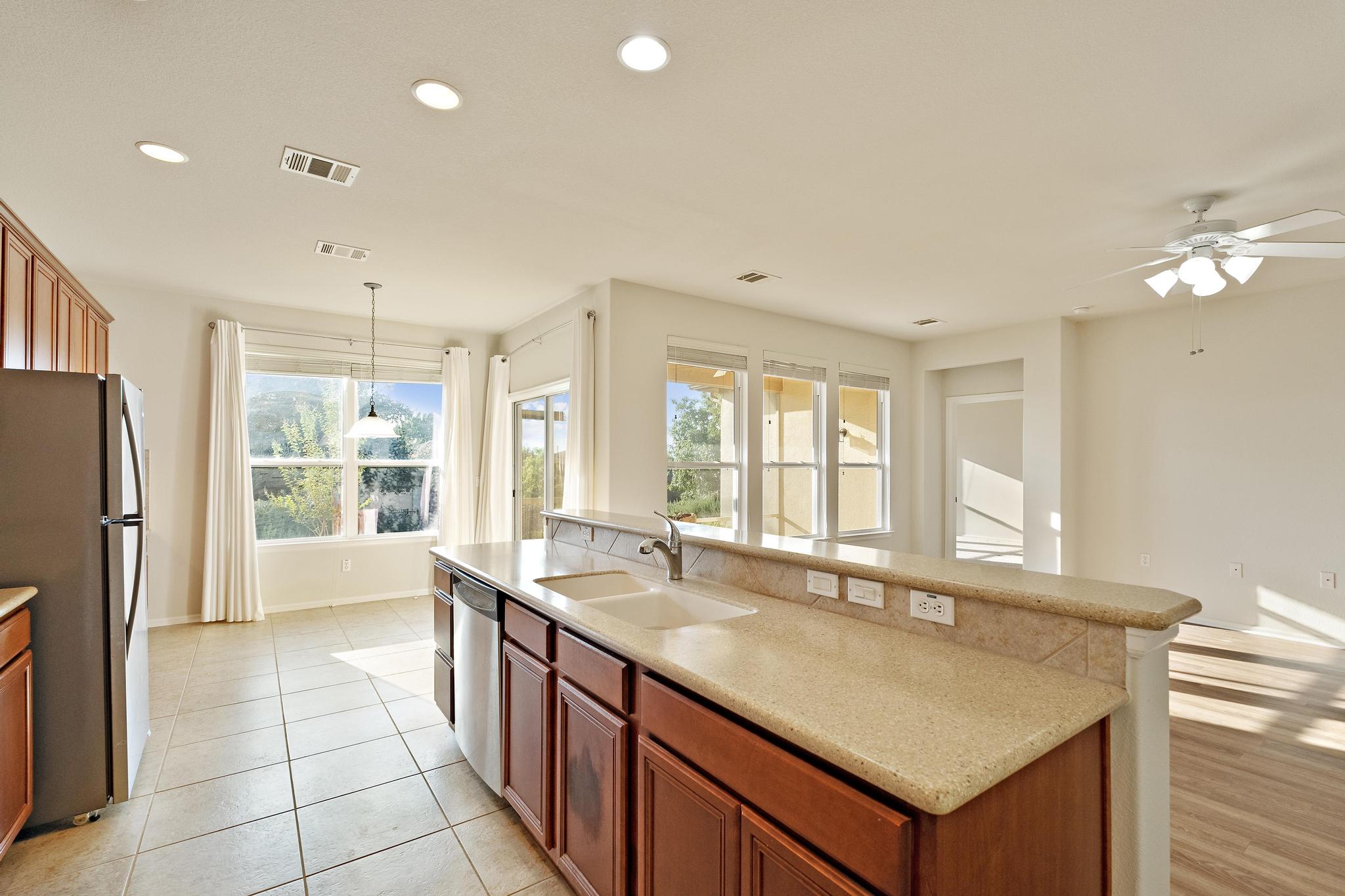 136 Prairie Creek Trail Georgetown, TX 78633 - Photo 7 of 31 a large kitchen with kitchen island a large window a sink and stainless steel appliances