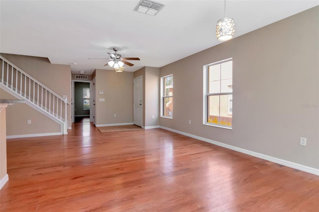 6952 Marble Fawn Place Riverview, FL 33578 - Photo 13 of 42 a view of an empty room with wooden floor and a window