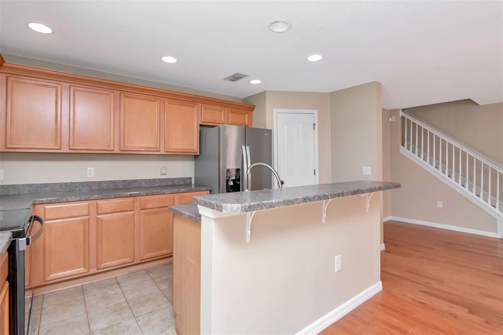 6952 Marble Fawn Place Riverview, FL 33578 - Photo 14 of 42 a kitchen with stainless steel appliances granite countertop a sink a stove a refrigerator with grey cabinets