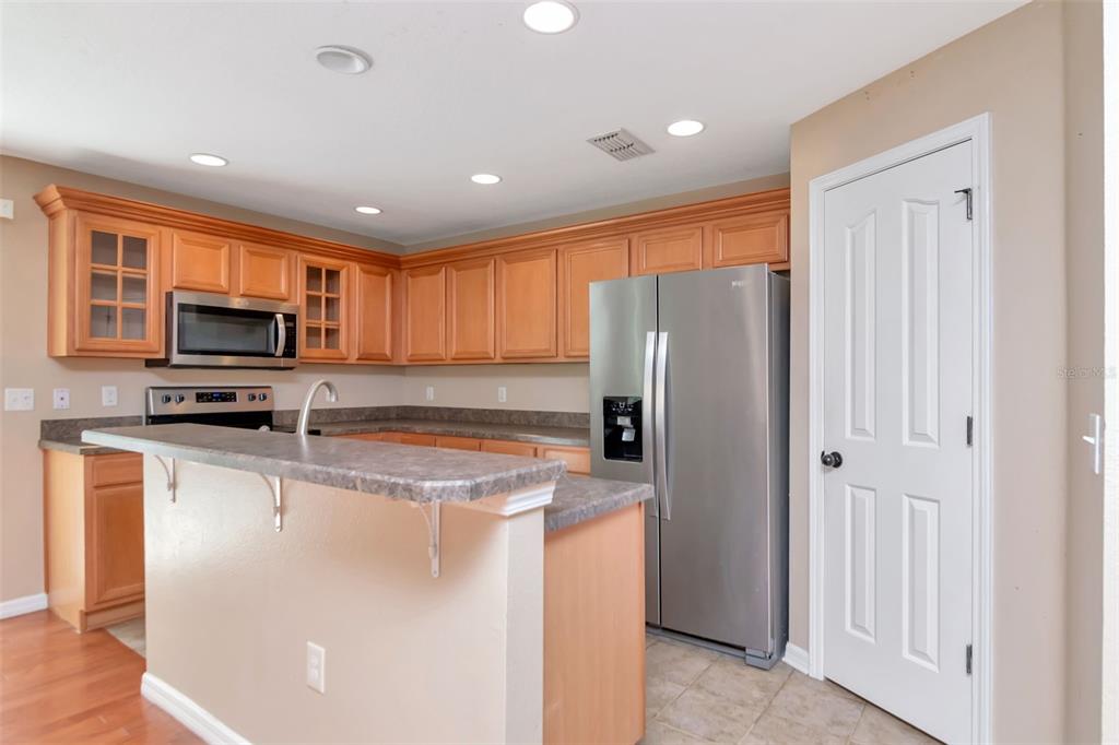 6952 Marble Fawn Place Riverview, FL 33578 - Photo 15 of 42 a kitchen with stainless steel appliances granite countertop a refrigerator a stove top oven a sink and dishwasher