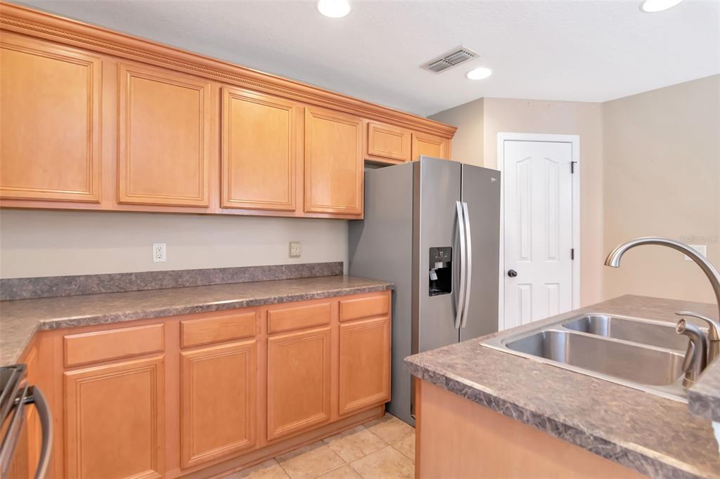 6952 Marble Fawn Place Riverview, FL 33578 - Photo 17 of 42 a kitchen with stainless steel appliances granite countertop a refrigerator sink and cabinets