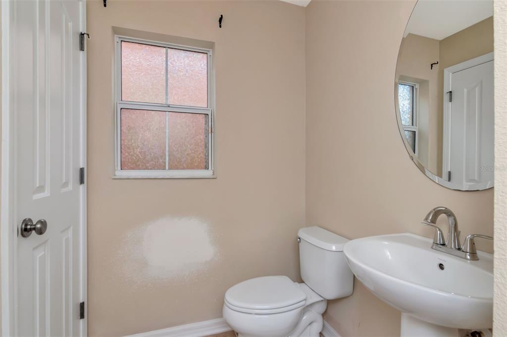 6952 Marble Fawn Place Riverview, FL 33578 - Photo 20 of 42 a white toilet sitting next to a bathroom sink
