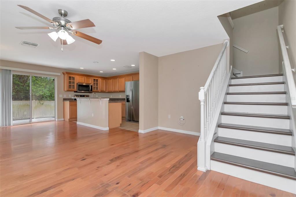6952 Marble Fawn Place Riverview, FL 33578 - Photo 3 of 42 a view of a kitchen with wooden floor and a ceiling fan