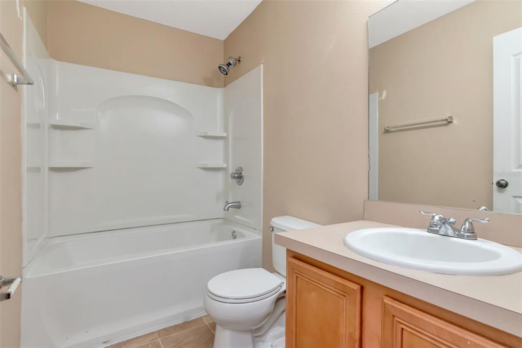 6952 Marble Fawn Place Riverview, FL 33578 - Photo 31 of 42 a bathroom with a sink toilet and a bathtub