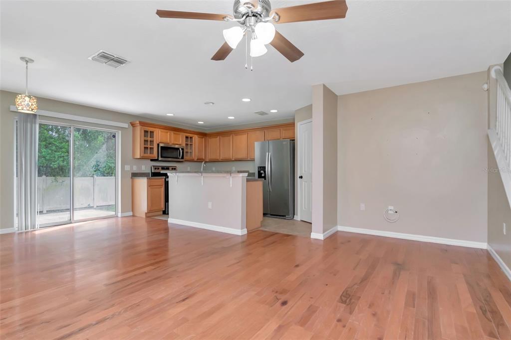 6952 Marble Fawn Place Riverview, FL 33578 - Photo 5 of 42 a view of a kitchen with a stove cabinets and wooden floor