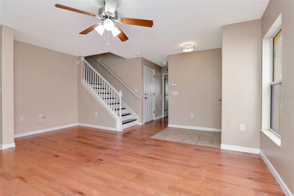 6952 Marble Fawn Place Riverview, FL 33578 - Photo 6 of 42 wooden floor in an empty room with a window