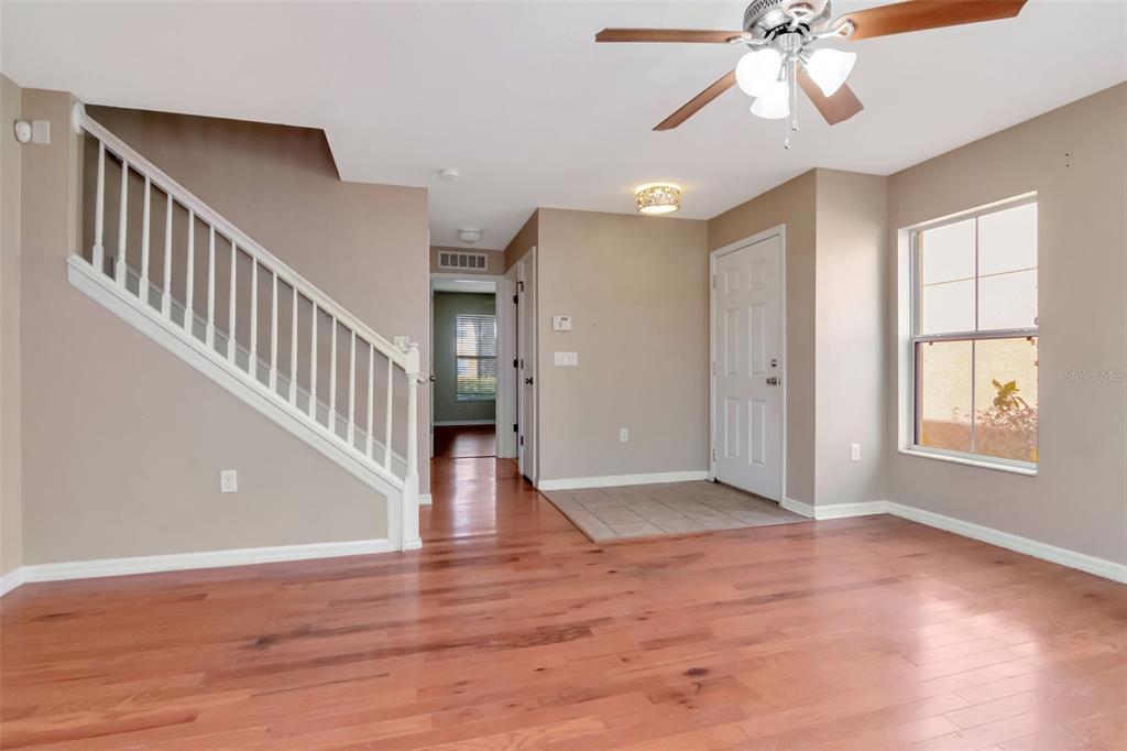 6952 Marble Fawn Place Riverview, FL 33578 - Photo 7 of 42 a view of an empty room with wooden floor and fan