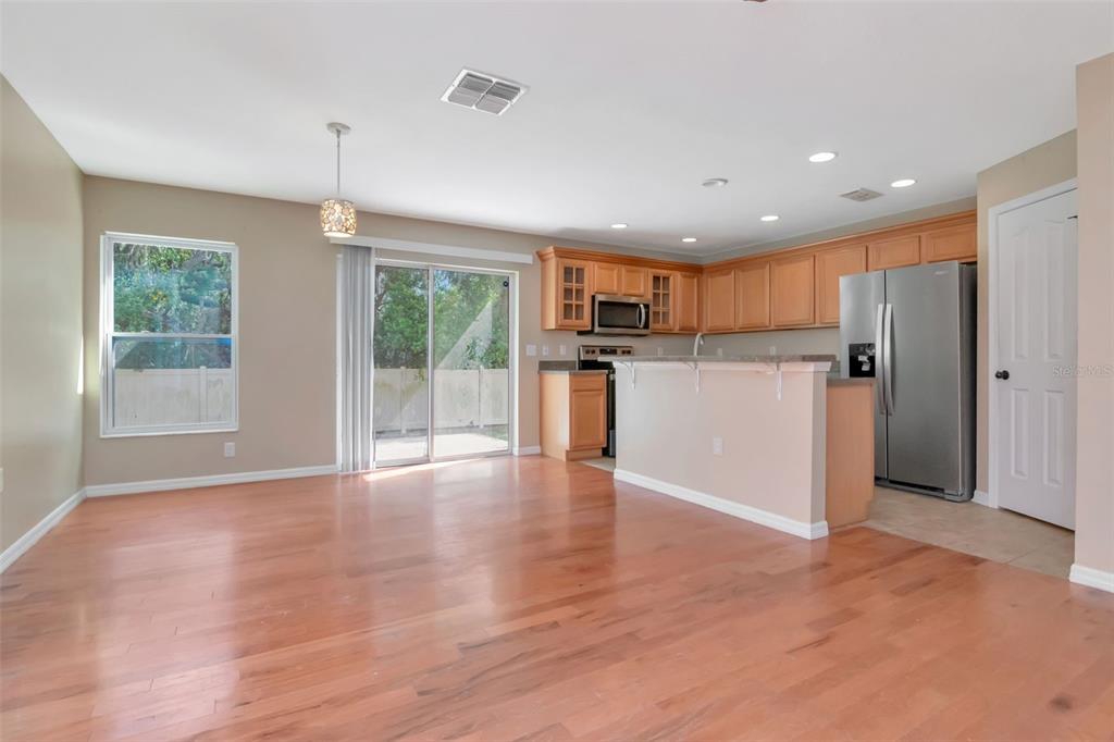 6952 Marble Fawn Place Riverview, FL 33578 - Photo 8 of 42 a view of a kitchen with a refrigerator wooden floor and a window