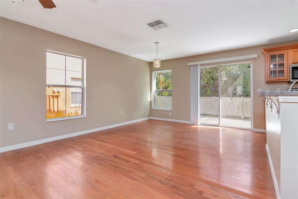 6952 Marble Fawn Place Riverview, FL 33578 - Photo 9 of 42 a view of an empty room with wooden floor and a window
