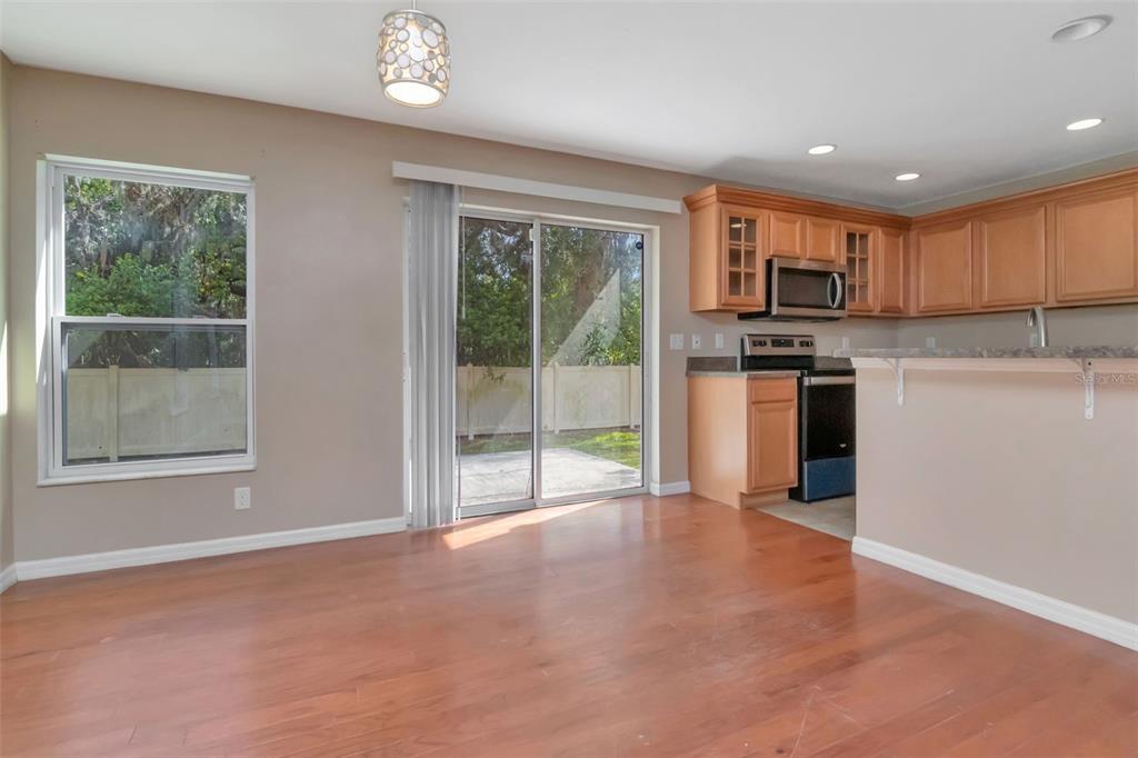 6952 Marble Fawn Place Riverview, FL 33578 - Photo 10 of 42 a view of kitchen with stainless steel appliances granite countertop a stove top oven a sink dishwasher and a refrigerator with wooden floor