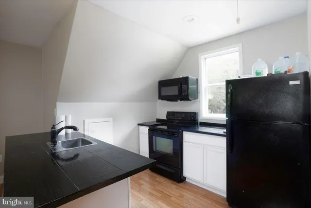 a kitchen with a sink a stove and refrigerator