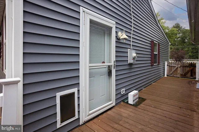 a view of deck in front of house with wooden stairs and seating space
