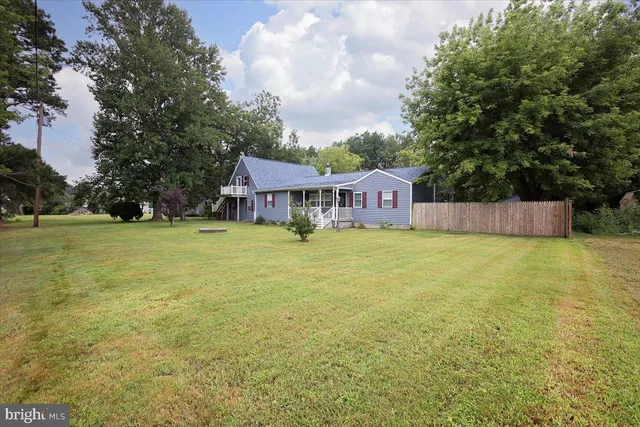 a view of a house with a yard and sitting area