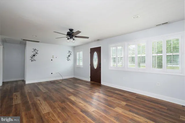 wooden floor in an empty room with a window