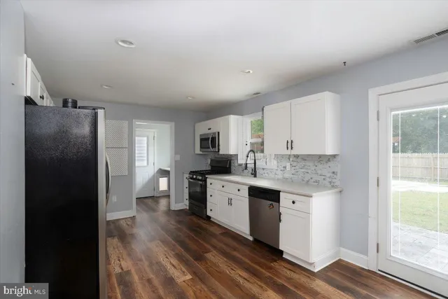 a kitchen with a sink stove and refrigerator