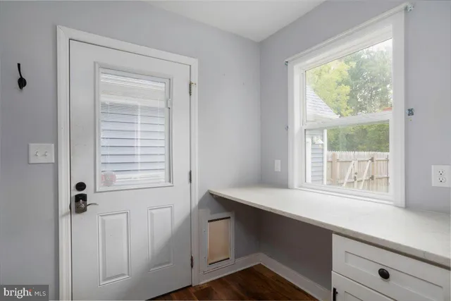 a room with a wooden floor and a window