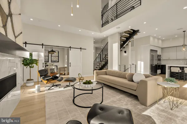 a living room with furniture a fireplace and a chandelier