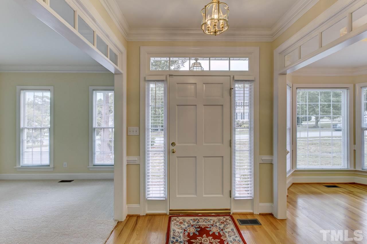 6805 Wilderness Road Raleigh, NC 27613 - Photo 2 of 25 a view of an entryway with a chandelier