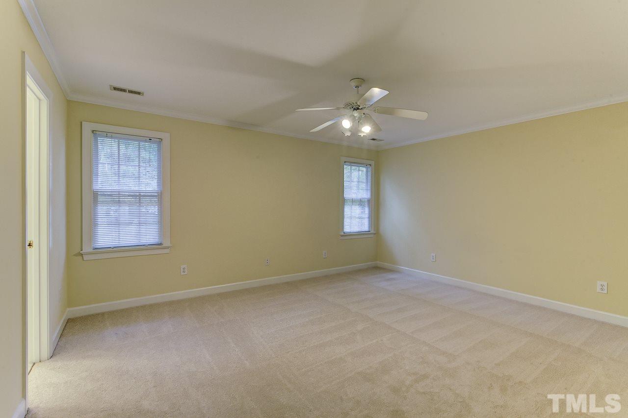 6805 Wilderness Road Raleigh, NC 27613 - Photo 13 of 25 an empty room with windows and fan