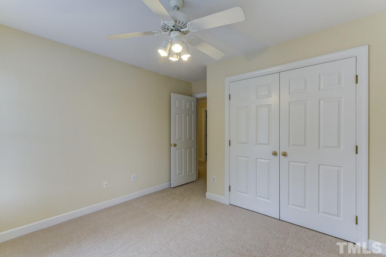 6805 Wilderness Road Raleigh, NC 27613 - Photo 18 of 25 a view of an empty room and chandelier fan