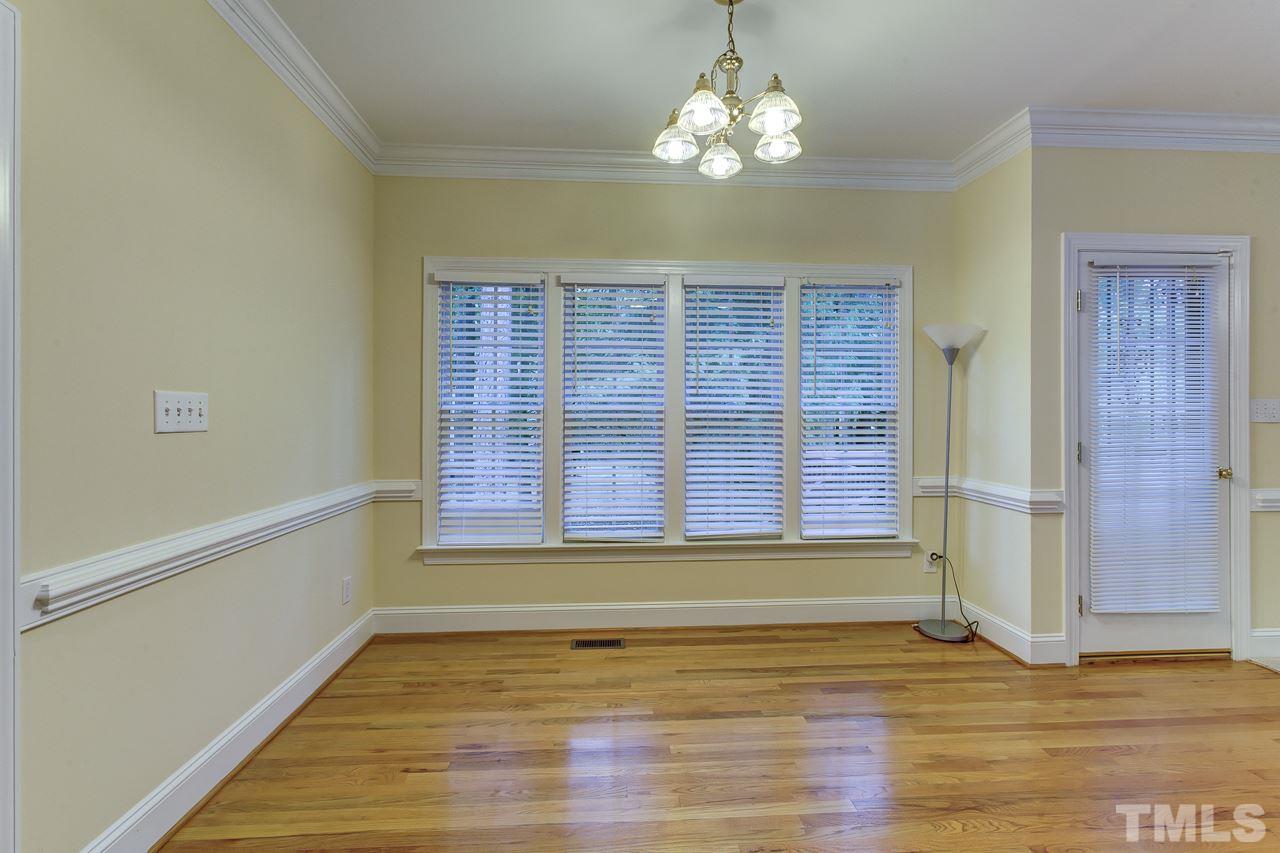 6805 Wilderness Road Raleigh, NC 27613 - Photo 10 of 25 a view of an empty room with wooden floor and a window