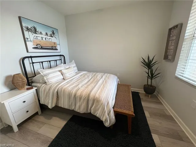 a bedroom with a large bed and a window