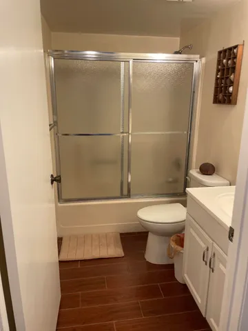 a bathroom with a toilet and a shower