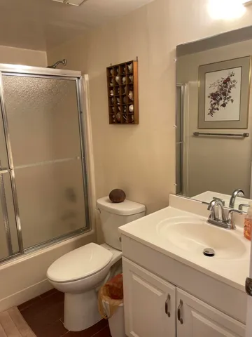 a bathroom with a sink a toilet and a shower