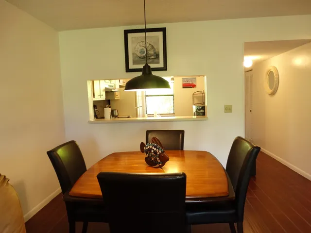 a dining room with furniture and wooden floor