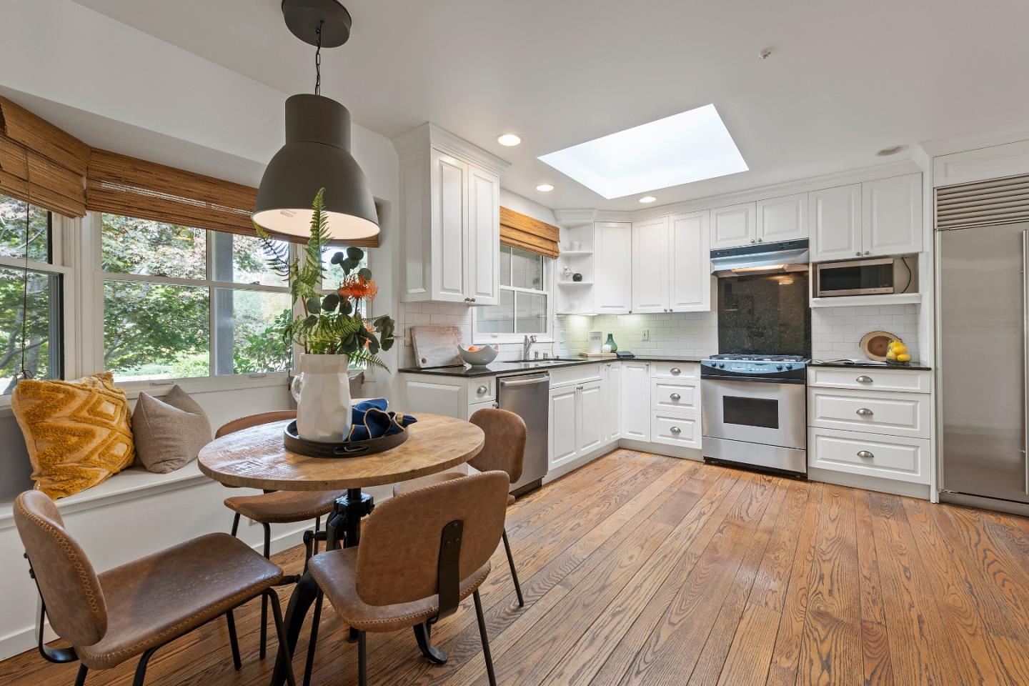1340 Hillview Drive Menlo Park, CA 94025 - Photo 10 of 29 a kitchen with stainless steel appliances granite countertop a stove top oven a dining table and chairs with wooden floor
