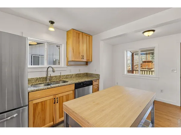 a bathroom with a granite countertop sink a mirror and a