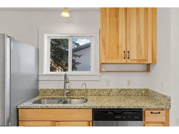 a view of kitchen with granite countertop cabinets