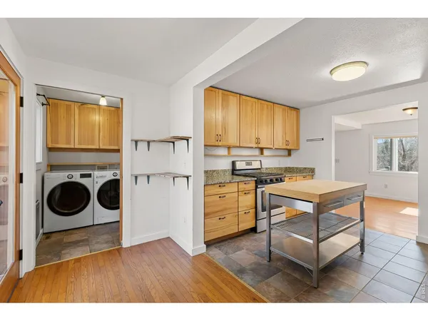 a view of a kitchen with fridge and workspace