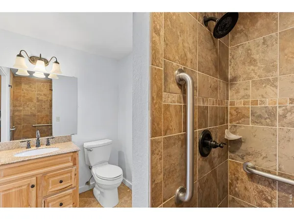 a bathroom with a toilet sink shower