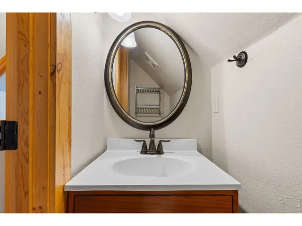 a bathroom with a sink a mirror and vanity