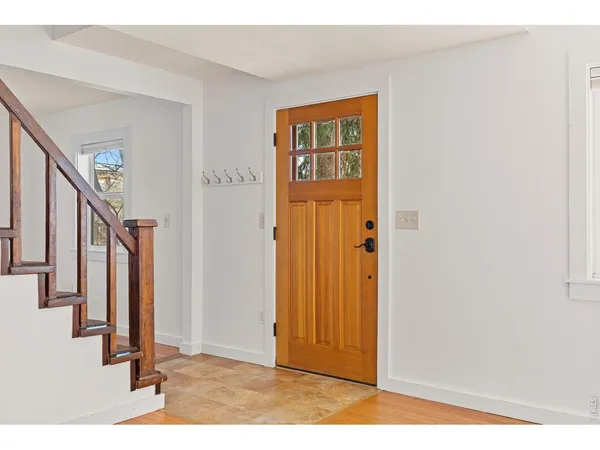 a view of an entryway with wooden floor